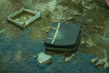 Waste and garbage thrown into the river. Water pollution and plastic garbage in the river