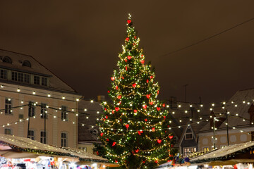 Christmas tree with decorations and lights, european Christmas market at night