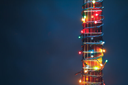 guitar finger-board with multicolor lights, festive background