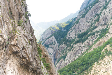 Perspective view at a space between two mountain slopes at sunrise.