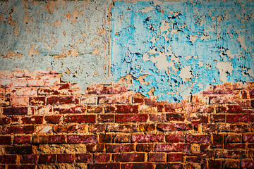 Half painted wall with peeling blue worn paint