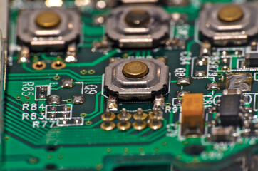 Fototapeta premium Green Circuit board, components and wires, macro photograph. Science and technology themes