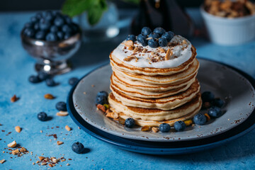 Stack of pancakes with fresh blueberry and maple syrup