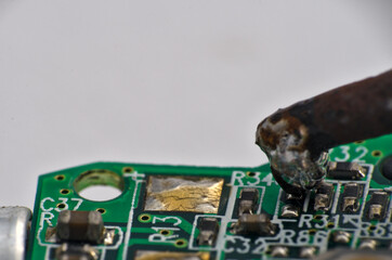 
Soldering iron and circuit board macro photograph. Science and technology themes