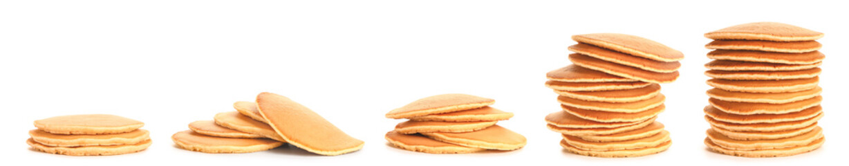 Many tasty pancakes on white background