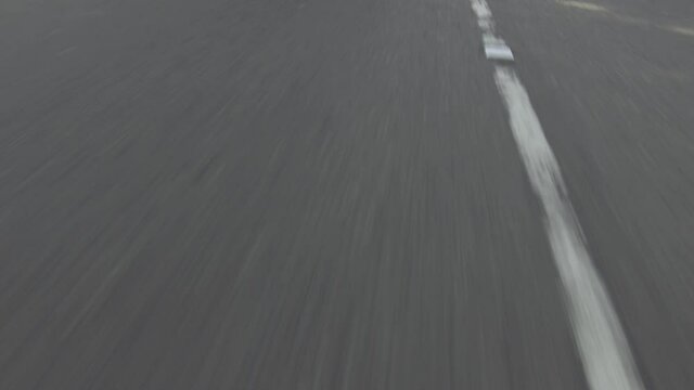 Macro Shot Of Asphalt Road While Driving On The Highway In Sri Lanka At Daytime - POV