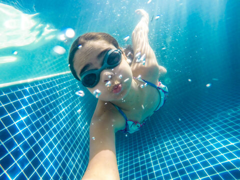 
family holiday at the farm recording every moment of fun in the pool