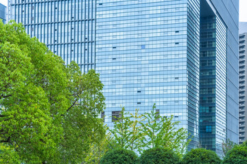 Fototapeta na wymiar modern office building with green trees.