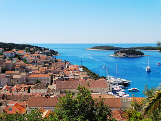 Aerial view of Hvar old city with port, old town, and island in Croatia. Hvar is a famous Croatian island for vacation.