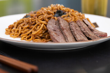 Korean traditional Jajjangmyeon black bean instant noodles on a plate.