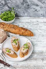 Turkey liver pate on whole grain baguette with microgreens