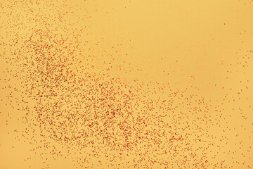 abstract background with small red glitter on yellow background