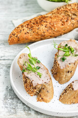 Turkey liver pate on whole grain baguette with microgreens