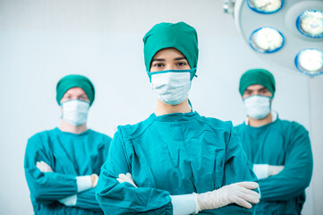 Portrait Of Multi-Cultural Surgical Team Standing In Hospital Operating Theater