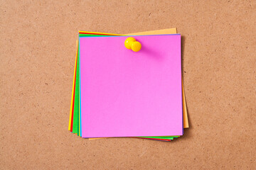 Colorful memo pads on the cork board
