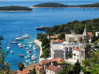 Obraz premium Aerial view of Hvar old city with port, old town, and island in Croatia. Hvar is a famous Croatian island for vacation.