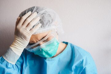 Portrait of stressed healthcare worker woman tired from work longtime in hospital during covid-19 pandemic outbreak.