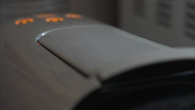 Placing a compostable coffee capsule on a coffee machine and pressing a button.