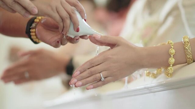 Watering the conch shell in a Thai wedding