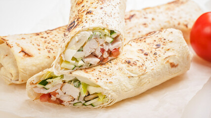 Traditional shawarma with chicken. Roll in a wheat tortilla with vegetables, salad and chicken. Turkish cuisine. Food banner format