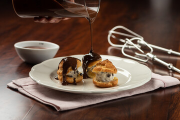 chocolate cream and cocoa profiteroles with hot melted dripping topping
