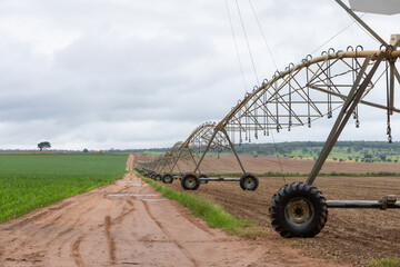 center pivot agricultural irrigation system watering on a farm