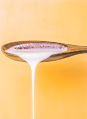 Kefir yougurt dripping from a spoon