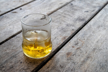 reused glass of whiskey on wood