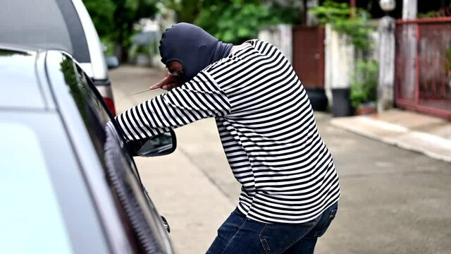 Robbery of a woman in a car. Thief use knife to threaten for steal money in a purse.