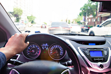 a hand driving with the steering wheel