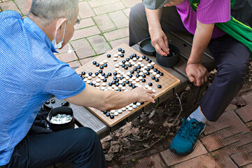 old people playing a game of go
