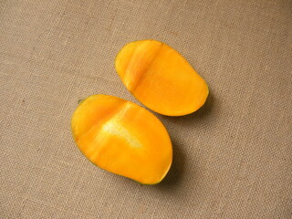 Cut halves of yellow color ripe fresh Mallika mango