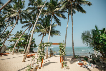 Naklejka premium Wedding venue, wedding setup, arch, decorated with flowers, beach wedding setup.Exotic ceremony wedding european style