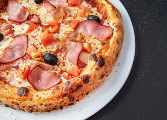 pizza on the black background, top view