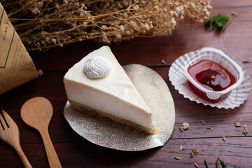 Ice box cheese cake with strawberry jam on the table.