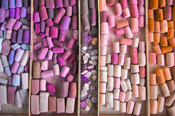 Top view of crayons of dry pastels in warm shades