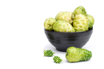 Noni fruit or Morinda citrifolia in bowl isolated on white background .