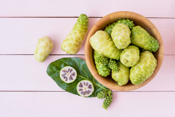 Noni fruit in bowl.