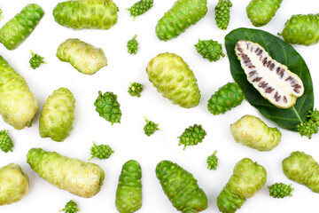 Closeup Noni fruit or Morinda citrifolia with slice and green leaf isolated on white background . Top view. 