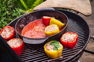 chef making stuffed pepper with tomato sauce