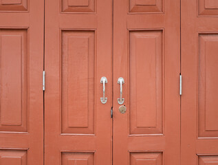 Old crimson red painted wooden door background. Vintage and retro style doors made of wood.