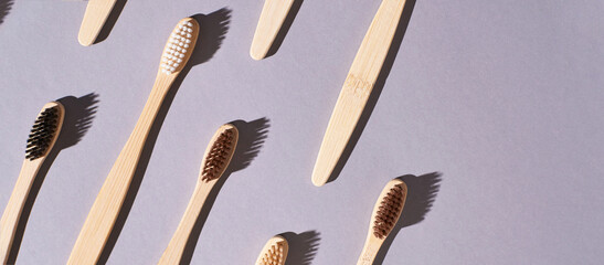 Set of bamboo toothbrushes. Different color. Ecology wood tooth brush group. Grey background....