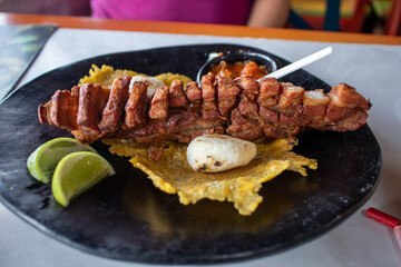 Fried pork belly with plantains and sauce 