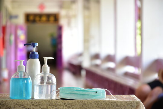 New normal, hand sanitizer, alcohol gel and hand soap on table in front of classroom. Concept for pretecting and preventing coronavirus or covid-19 and germs.