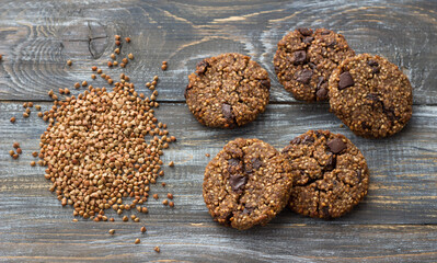 Healthy gluten-free buckwheat cookies with chocolate on wooden table