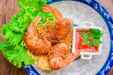 Goong Sarong  noodles Wrapped Shrimp With Crispy Noodle Serve, vegetable and sauce in vintage plate...