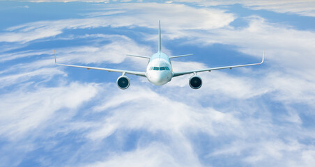 Fototapeta na wymiar White passenger airplane in the clouds - Travel by air transport