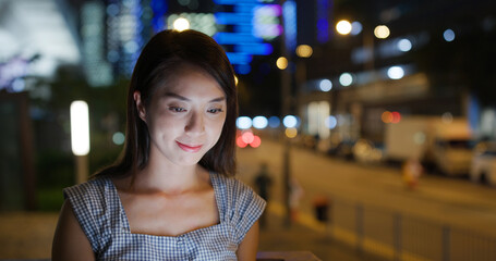 Woman use of tablet computer at street