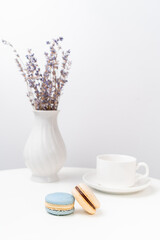 macarons on background Cup and vase with lavender.