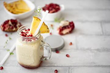 milkshake with pineapple and pomegranate seeds
